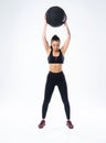 Fit and strong female athlete working out with a medicine ball to get better core strength and stability