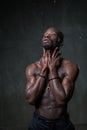 Fit strong physique African American young man wearing black hat and trousers posing dancing Royalty Free Stock Photo