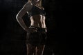 Fit and strong sport woman holding posing defiant in cool attitude with welt built body