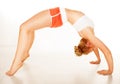 Fit supple woman arching over her back