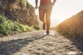 Fit tattoo man doing jogging session alone during Coronavirus quarantine  - Workout and fitness lifestyle concept - Focus on feet Royalty Free Stock Photo