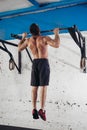 Fit toes to bar man pull-ups bars workout exercise at gym Royalty Free Stock Photo
