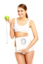 Fit woman with apple tape and scales