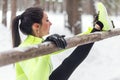 Fit woman athlete doing hamstring leg stretching exercises outdoors in woods. Female sports model exercising outdoor Royalty Free Stock Photo