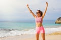 Fit woman on the beach feeling excited Royalty Free Stock Photo