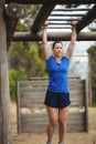 Fit woman climbing monkey bars Royalty Free Stock Photo