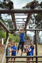 Fit woman climbing monkey bars Royalty Free Stock Photo