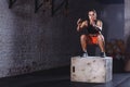 Fit woman doing box jump exercise. Muscular woman doing box jumps at gym Royalty Free Stock Photo