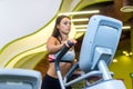 Fit woman doing cardio in an elliptical trainer in a gym. Royalty Free Stock Photo