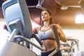 Fit woman doing exercise on a elliptical trainer. Royalty Free Stock Photo