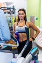 Fit woman doing exercise on a elliptical trainer. Royalty Free Stock Photo