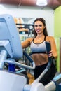 Fit woman doing exercise on a elliptical trainer. Royalty Free Stock Photo