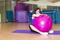 Fit Woman doing exercises with a ball on a Mat in a Gym Royalty Free Stock Photo