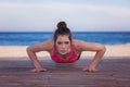 Fit woman doing push up or press up