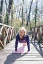 Fit woman doing yoga in forest. Royalty Free Stock Photo