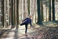Fit woman doing yoga in forest. Royalty Free Stock Photo