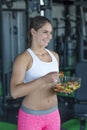 Fit woman eating healthy salad after workout Royalty Free Stock Photo