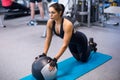 Fit woman exercising with medicine ball workout out arms Exercise training triceps and biceps doing push ups