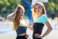 Fit woman and girl standing in sportswear on the sports ground
