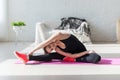 Fit woman high body flexibility stretching her leg