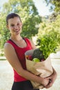 Fit woman holding bag of healthy groceries Royalty Free Stock Photo