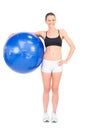 Fit woman holding exercise ball smiling at camera Royalty Free Stock Photo