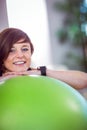 Fit woman leaning on exercise ball Royalty Free Stock Photo