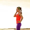 Fit woman looking into the distance and listening to the music Royalty Free Stock Photo