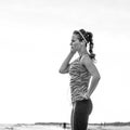 Fit woman looking into the distance and listening to the music Royalty Free Stock Photo