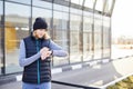 Fit woman looking at smartwatch and counting calories burned. Woman standing relaxed after workout Royalty Free Stock Photo