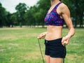 Fit woman in park with jump rope Royalty Free Stock Photo