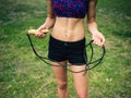 Fit woman in park with jump rope Royalty Free Stock Photo