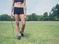 Fit woman in park with jump rope Royalty Free Stock Photo