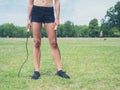 Fit woman in park with jump rope Royalty Free Stock Photo