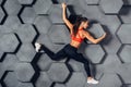 Fit woman posing like a climber hanging on decorative wall Royalty Free Stock Photo