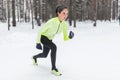Fit woman in position ready to run outdoors winter park Royalty Free Stock Photo
