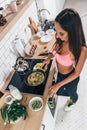 Fit woman preparing low carb meal in the kitchen Top view Royalty Free Stock Photo