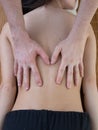 fit woman receiving back man massage at salon spa Royalty Free Stock Photo