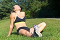 Fit woman resting in the sun after a workout Royalty Free Stock Photo