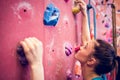 Fit woman rock climbing indoors Royalty Free Stock Photo