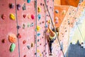 Fit woman rock climbing indoors Royalty Free Stock Photo