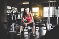 Fit woman sitting and relax after the training session in gym,Concept healthy and lifestyle,Female taking a break after exercise a Royalty Free Stock Photo
