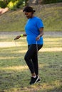 Fit woman skipping rope in the park Royalty Free Stock Photo