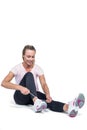 Fit woman smiling while tying shoelace Royalty Free Stock Photo