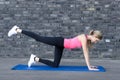 Fit woman strengthening her thigh muscles