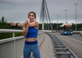 Young female athlete stretching warming up on bridge Royalty Free Stock Photo