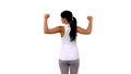 Fit woman tensing arm muscles rear view