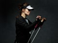 Fit woman training with resistance band against dark background Royalty Free Stock Photo