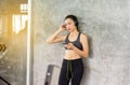 Fit woman using headphone and listening to music while relax after the training session in gym,Concept healthy and lifestyle,Femal Royalty Free Stock Photo