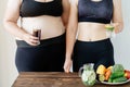 Fit woman with water and obese woman with soda